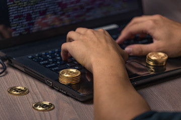 Dangerous hooded hacker on laptop breaks computer security sistem and steal bitcoin cryptocurrency