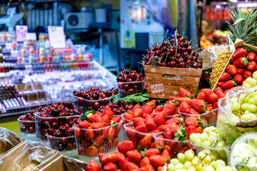 Strawberries and cherries sold on the market