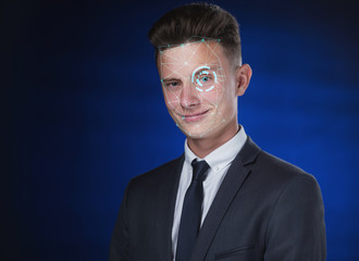 identification of the face of a young guy, a student in a suit on a blue background