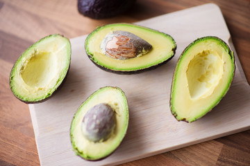 Close-up of a fresh juicy avocado on wooden table. Healthy concept