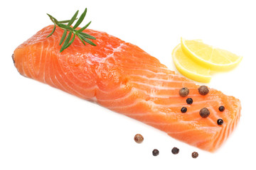 Red fish. Raw salmon fillet with rosemary and lemon isolate on white background.