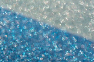 Abstrast blurred glittery shiny background, blue and silver, defocused