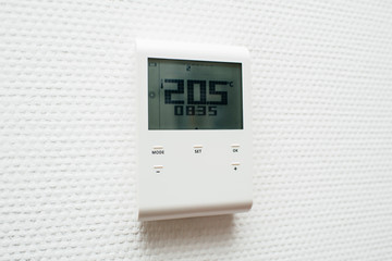 New modern electronic thermostat in the interior of the house office the temperature with wall thermostat regulator with digital humidity, temperature, climate setting