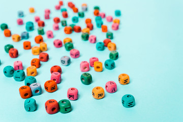 Colored cubes with letters on a blue background.