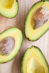 Close-up of a fresh juicy avocado on wooden table. Healthy concept