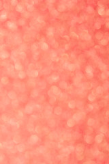 Abstrast blurred glittery shiny background, coral, colur of the year 2019