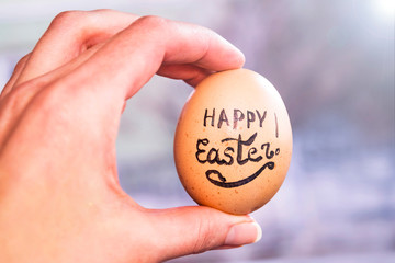 Happy Easter! Female hand holding egg