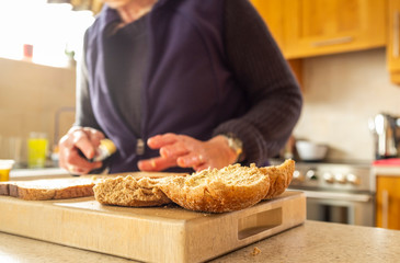 Woman making egg and onion sandwiches