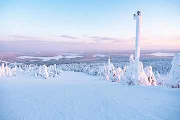 Snow-covered nature of Lapland, winter ski slope.