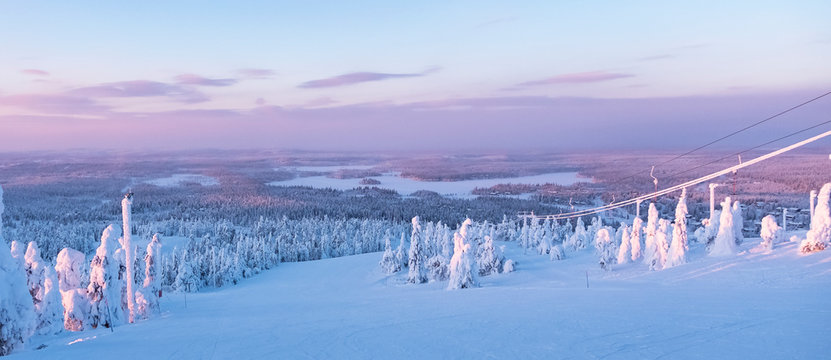 Snow-covered nature of Lapland, winter ski slope.