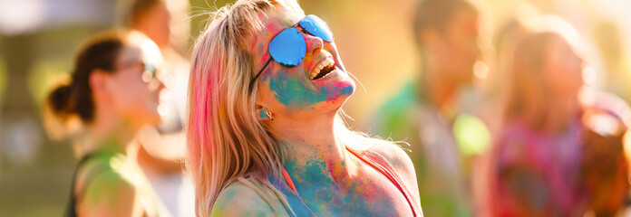 Colored girl laughs at the Holi festival