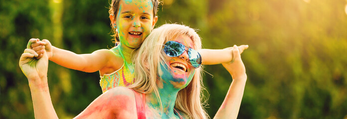 Mother and daughter playing at the festival of paints