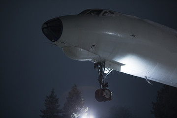 Naklejka na ściany i meble Close-up of old airplane over background of night sky.