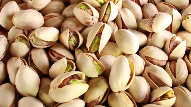 Pistachios pistachio nuts nut food closeup texture pattern seamless looping rotating video footage hd resolution.