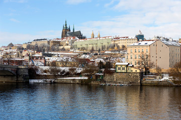 Fototapeta premium Snowy Prague Lesser Town with Prague Castle above River Vltava in the sunny Day, Czech republic