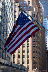 American flag blowing in Philadelphia in front of high rise buildings