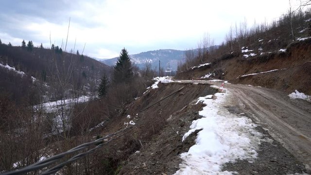Man goes next to landslide road - (4K)