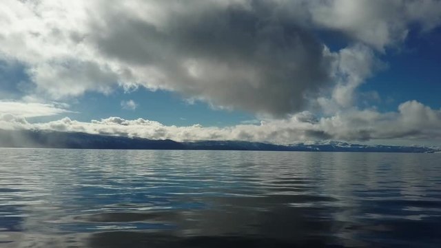 Reflective water with clouds and blue sky