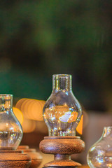 Beautiful vintage lamplight made from glass and coconut palm wood, the famous local product of the Southern Thailand  for sale in night market in Bangkok. Night shot with grain.