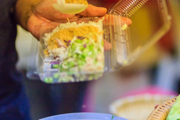 Vendor is selling for Nasi kerabu or khao yum, the popular food in Southern Thai-Style rice with herbs and vegetables. Nasi kerabu is a Malay rice dish, a type of nasi ulam.
