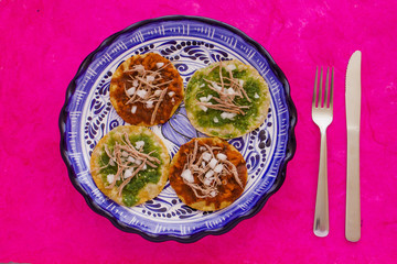 chalupas poblanas, mexican food Puebla Mexico on a pink background