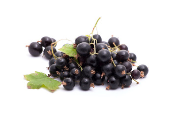 A handful of black currants on a white background. Isolated