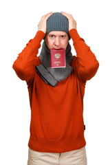 The Caucasian man with the international passport of the Russian Federation in warm clothes clutched hands at the head