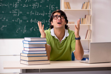 Handsome student in front of chalkboard with formulas