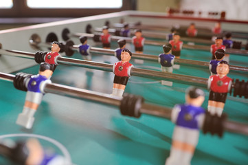 friends - guys and girls play table football.