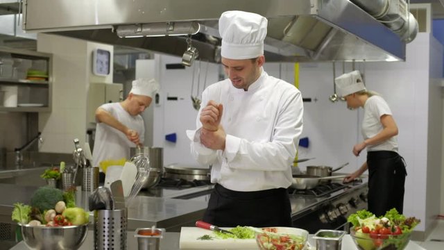 chef preparing salad then hurts wrist injury