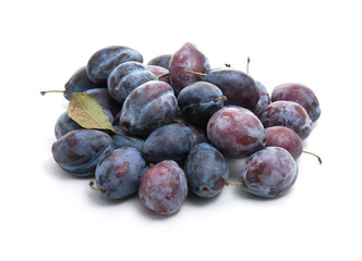 A pile of plums on a white background. Isolate. Studio photography