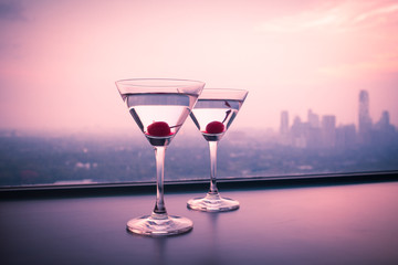  martini glasses against city background 