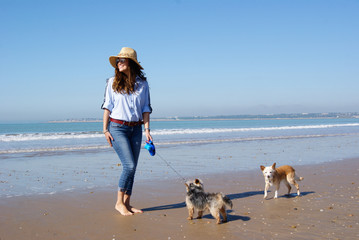 Young girl walking around the beach with her dogs in Puerto de Santa María,Andalucía,Spain