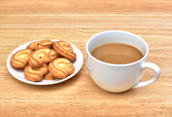 Coffee drink is on wooden table with cookie in coffee time