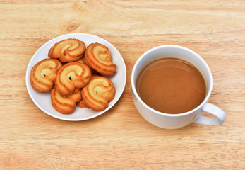 Coffee drink is on wooden table with cookie in coffee time