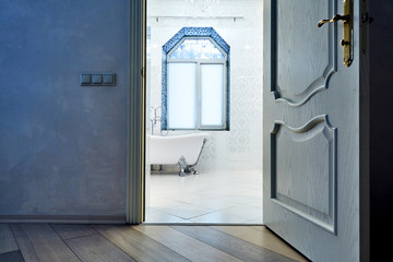Beautiful Interior of a Modern Bathroom. Interior Architecture. View through open doors