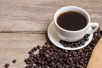 Coffee cup and coffee beans on Plank
