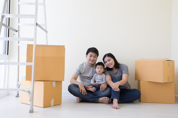 Mother father and son in a new home. Housing a young Asian family concept