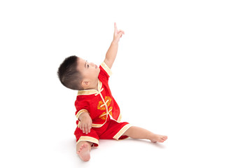 Asian baby boy sit and pointing to top and wearing traditional Chinese suit isolated on white background, Dress up for Chinese new year festival concept, One year six month infant model