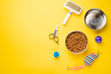 Pet, cat, food and accessories of cat life flat lay, with space for design, on yellow background
