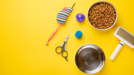 Pet, cat, food and accessories of cat life flat lay, with space for design, on yellow background