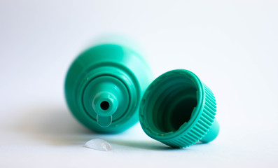 Green plastic eye dropper bottle isolated on white background.