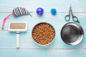 Pet, cat, food and accessories of cat's life flat lay, on a blue background. Background for design.