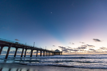 Fototapeta na wymiar Sunset behind the pier at Manhattan Beach, California