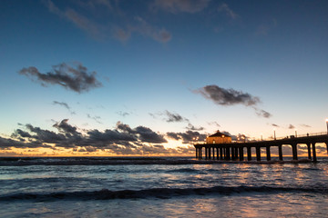 Fototapeta na wymiar Sunset behind the pier at Manhattan Beach, California