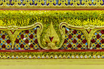Beautiful golden base of the movable throne in Thai's style patterns for contain the Lord Buddha relics enshrined. Located at the departure floor of Suvarnabhumi airport, Bangkok, Thailand.