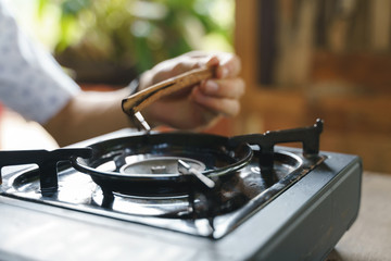 Grill cinnamon stick on portable stove
