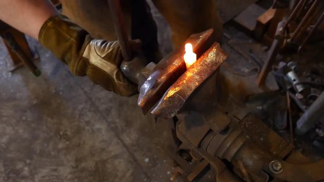 A Blacksmith Setting Hot in the Leg Vise and Using a Air Hammer for Forging a Tennon