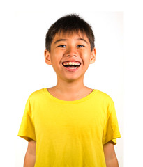 portrait of young happy and excited child smiling and laughing cheerful wearing yellow t-shirt...
