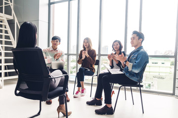 Group of casual business meeting and discussing.Successful business people clapping hands in the meeting.Teamwork concept